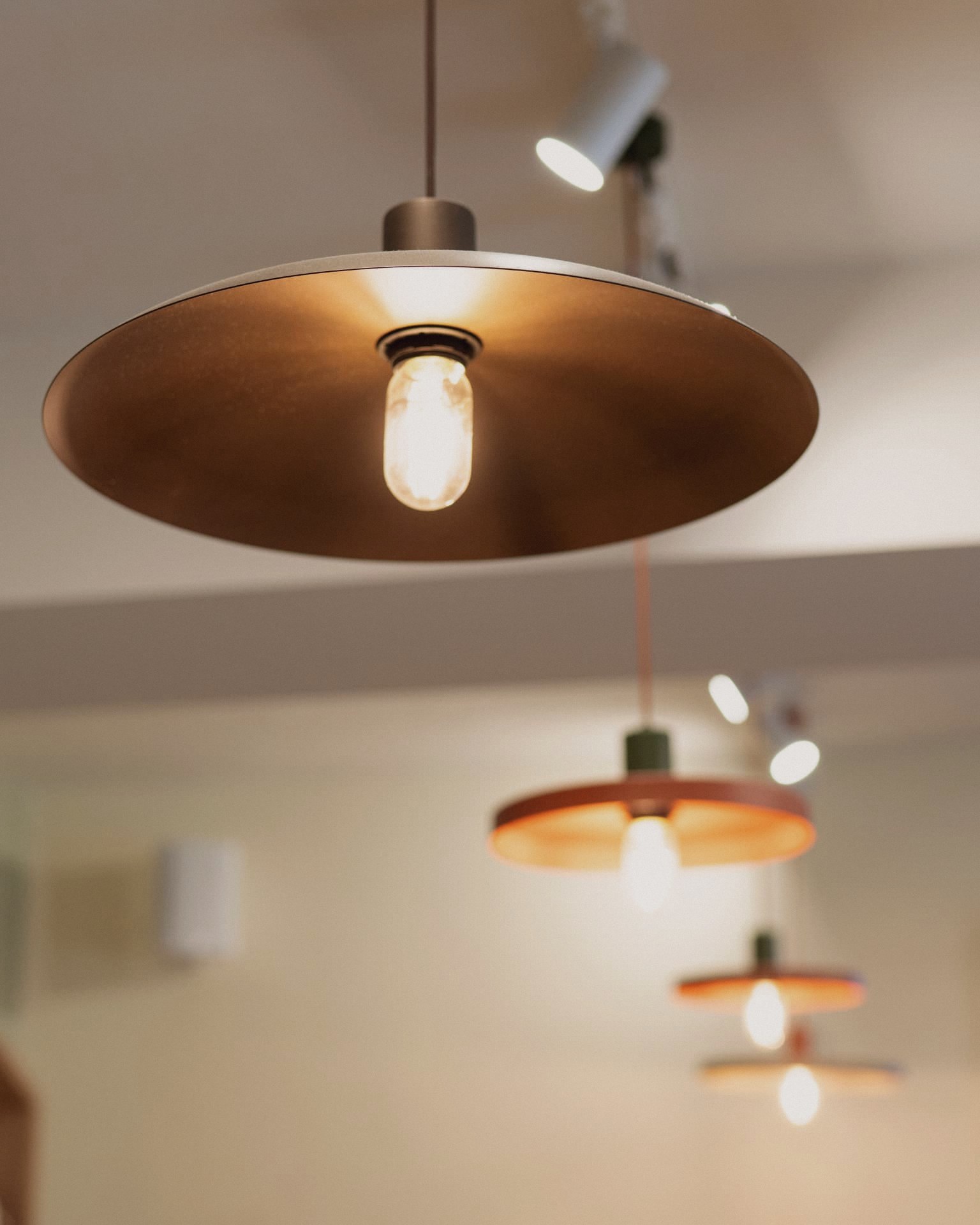 Warm pendant lights above the tables at Fumiglia
