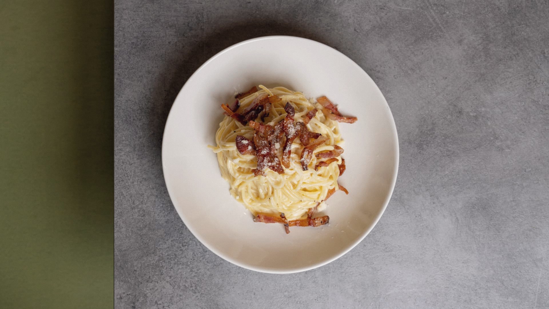 Classic carbonara with crisp pancetta and pecorino, shot from above