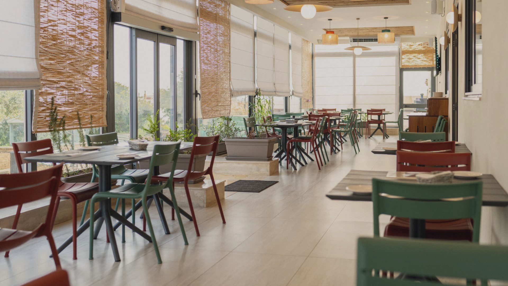 Sunlit Fumiglia dining room with cane blinds and open windows